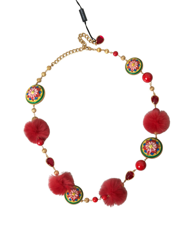 a necklace with red beads and pom poms