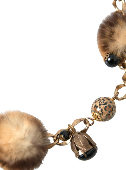 a close up of a key chain with a fur ball