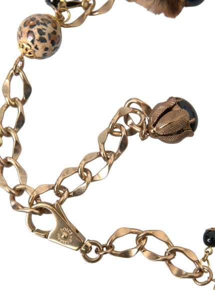 a close up of a gold chain with charms