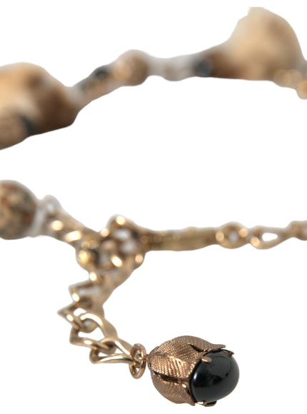 a close up of a necklace with a ball on it