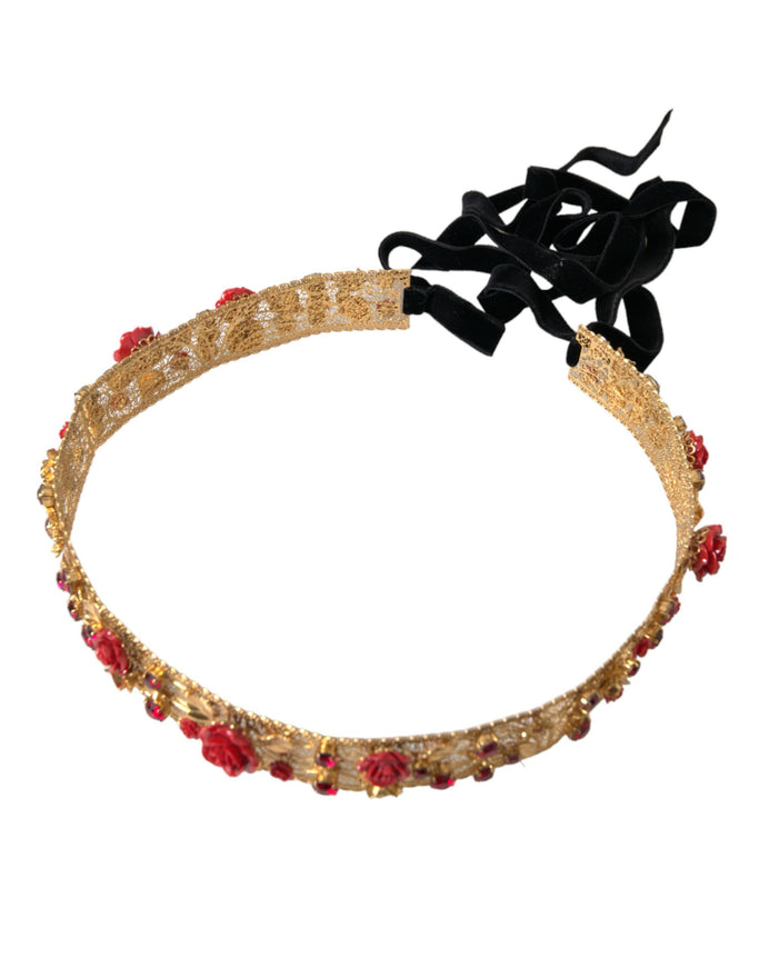 a gold headband with red beads and a black bow