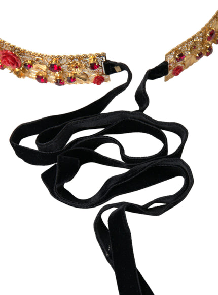 a gold and red necklace with a black cord