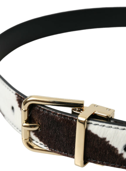 a cow print belt with a gold buckle