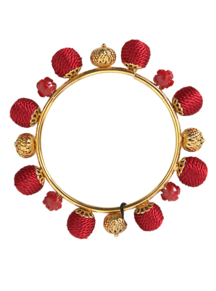 a gold and red bracelet with red beads