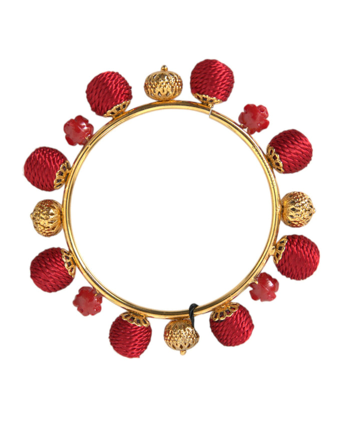 a gold and red bracelet with red beads