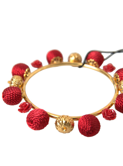 a red bracelet with gold balls and beads