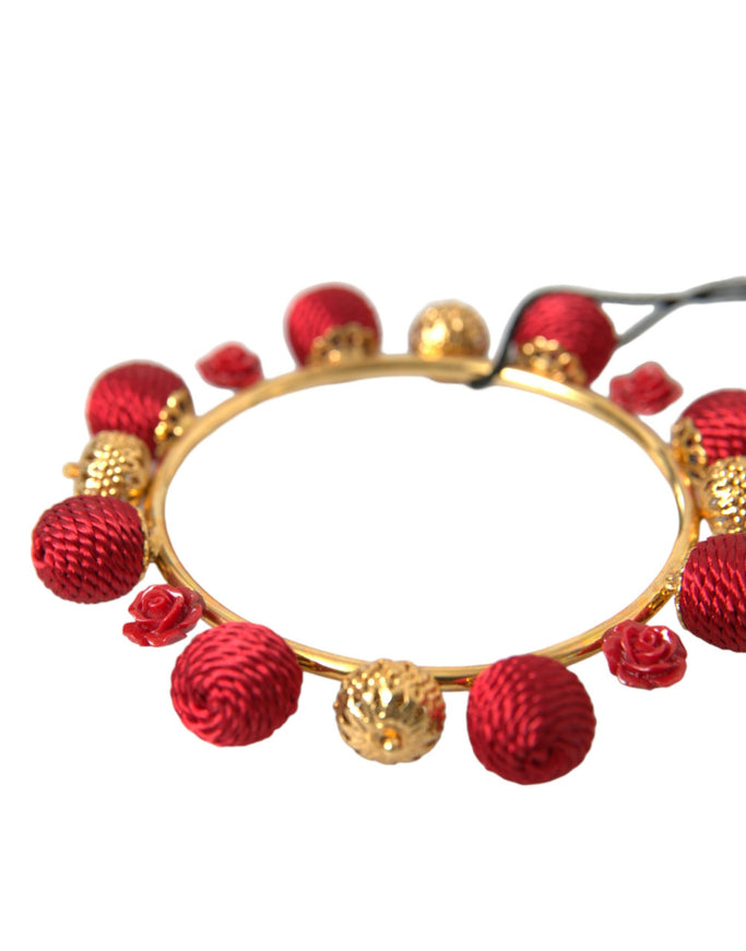 a red bracelet with gold balls and beads