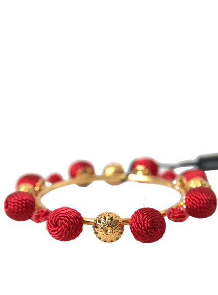 a close up of a red and gold bracelet