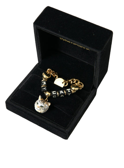 a gold bracelet with a cat charm in a black box