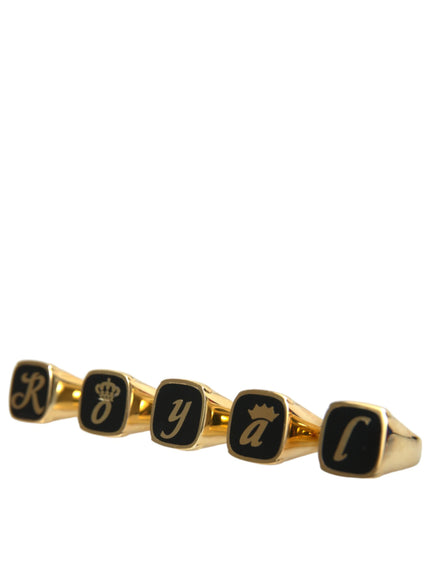 a gold ring with black letters and a crown