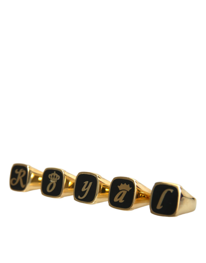 a gold ring with black letters and a crown