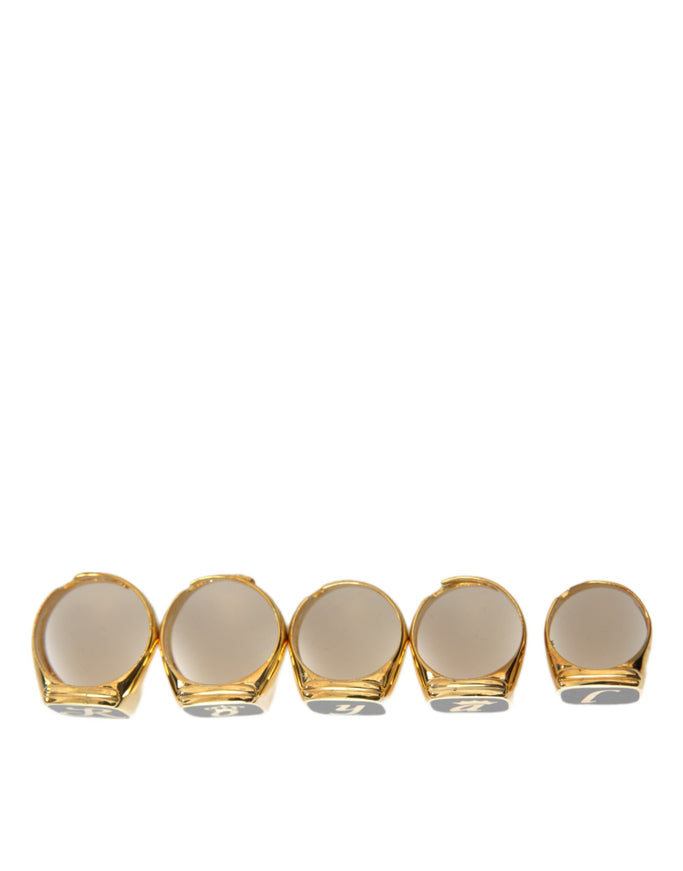 a set of four gold plated dishes on a white background