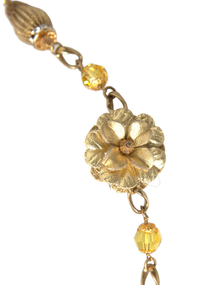 a gold bracelet with a flower on it