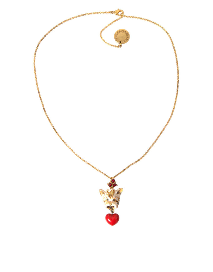 a gold necklace with a red heart on it