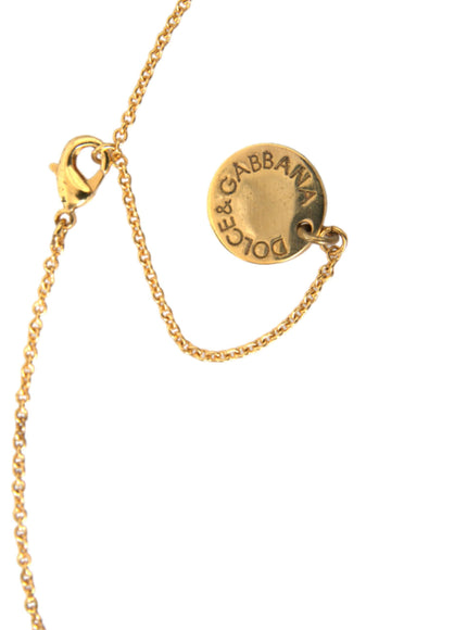 a close up of a gold necklace with a name on it