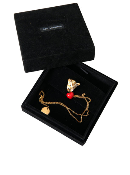 a black box with a gold necklace and a red heart