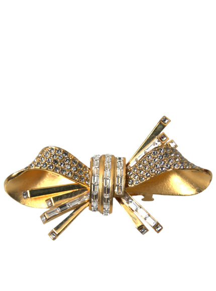 a gold bow brooch with crystal stones