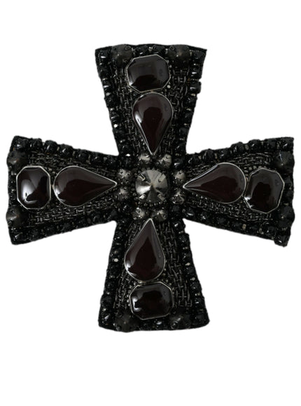 a black and white cross shaped broochle on a white background