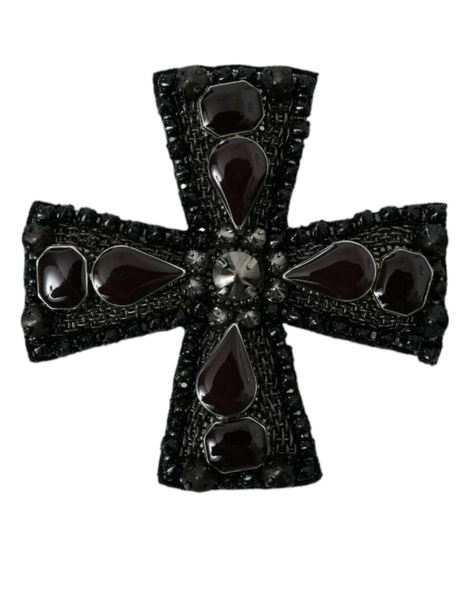 a black and white cross shaped broochle on a white background