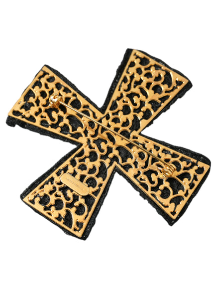 a gold and black brooch with an animal print pattern