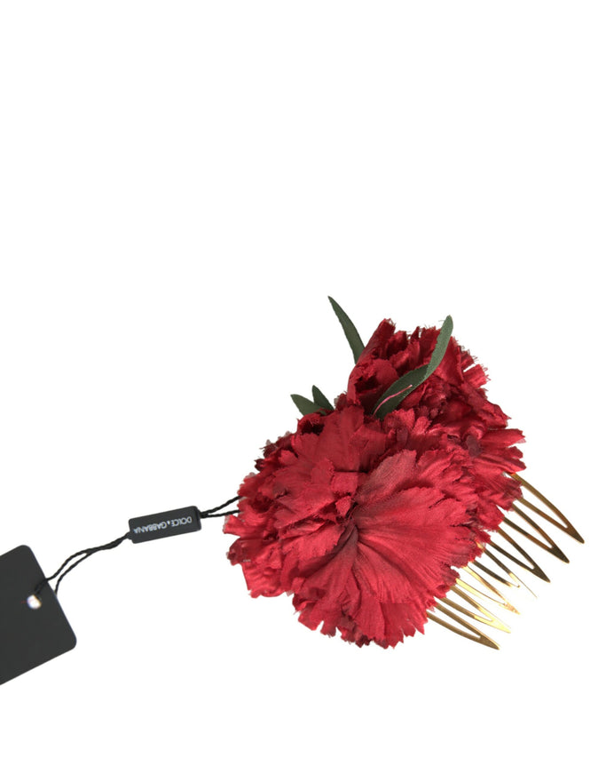 a red flower with a hair comb attached to it