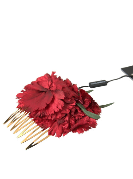 a red flower with a long metal comb attached to it