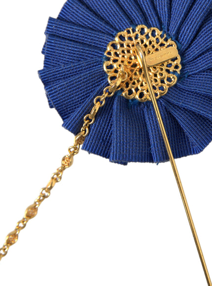 a blue pinwheel with a gold chain attached to it