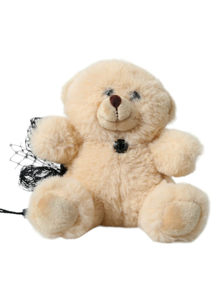 a stuffed teddy bear with a black ribbon around its neck