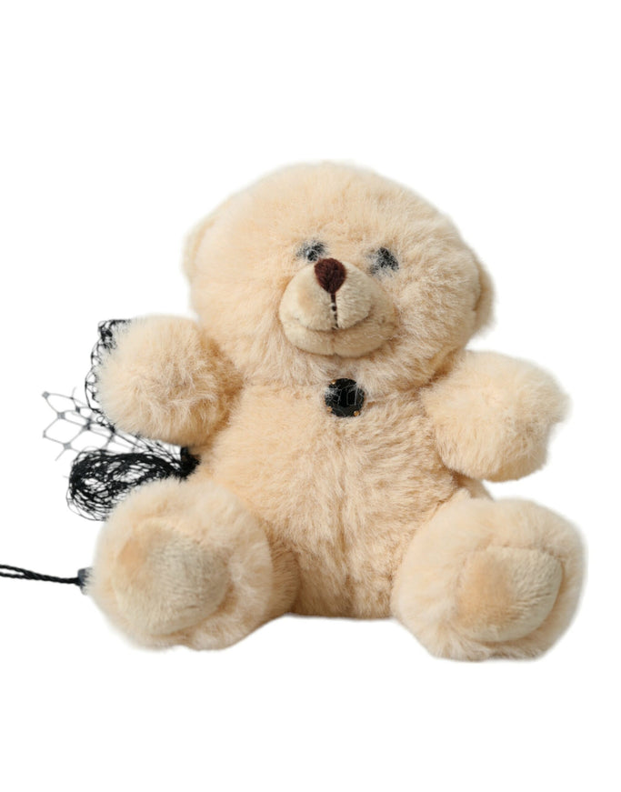 a stuffed teddy bear with a black ribbon around its neck