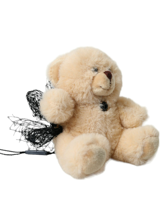 a stuffed teddy bear with a black ribbon around its neck