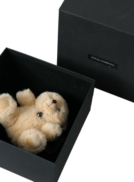 a small teddy bear in a black box