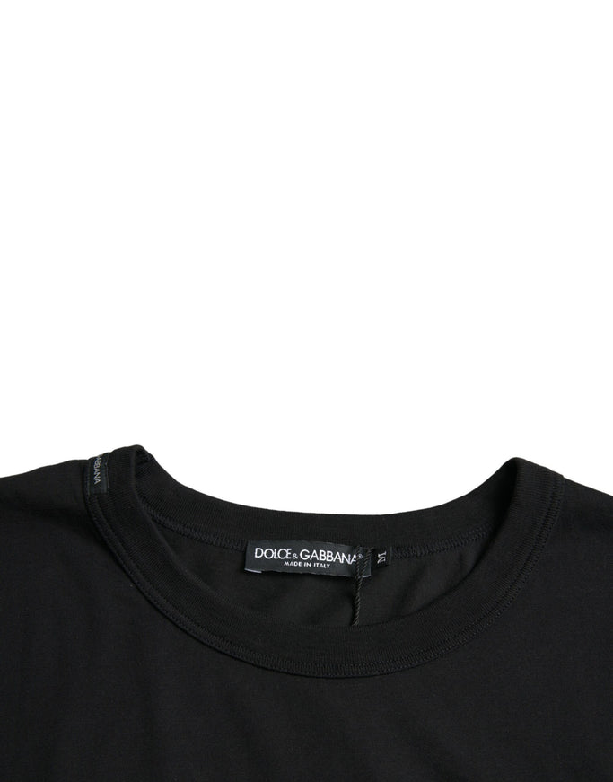 a black t - shirt with a black logo on the chest