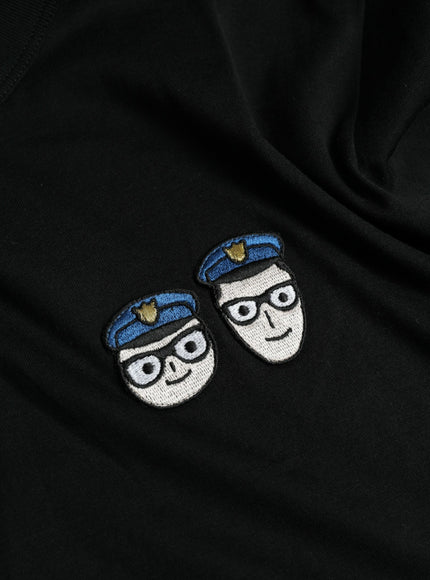 two patches on a black sweatshirt with a white background