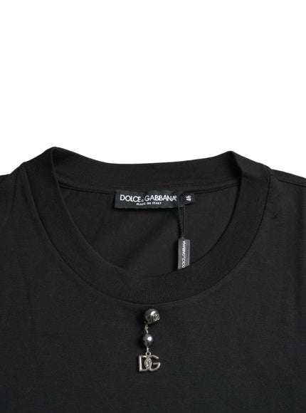 a black t - shirt with a silver logo on the chest