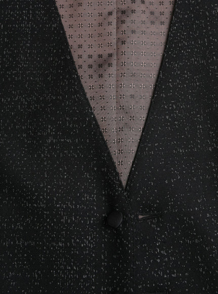 a close up of a man wearing a suit and tie