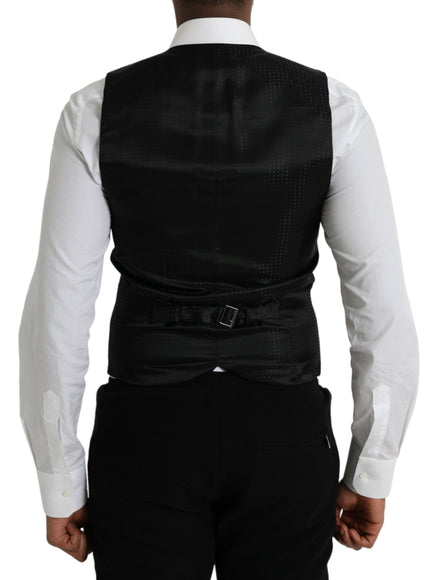 a man wearing a black vest and white shirt