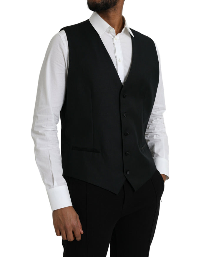 a man wearing a black vest and white shirt