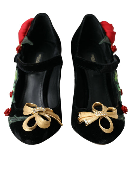 a pair of black shoes with a rose on the heel