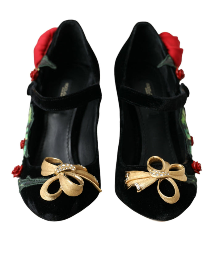 a pair of black shoes with a rose on the heel