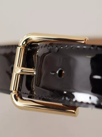 a close up of a black belt with a gold buckle