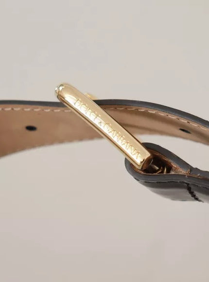 a close up of a leather belt with a gold buckle