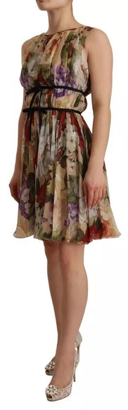 a woman wearing a dress with flowers on it