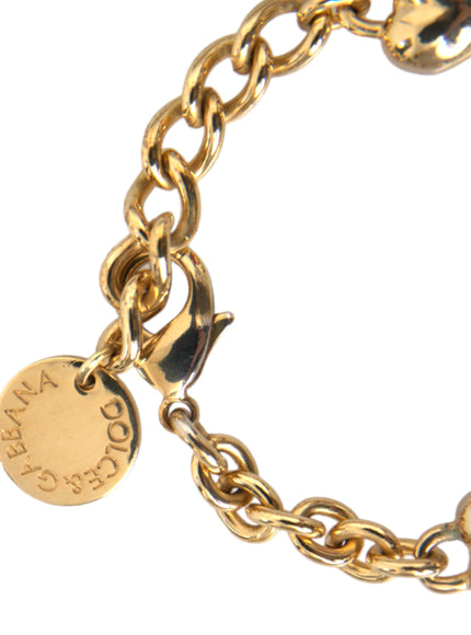 a close up of a gold bracelet with a charm