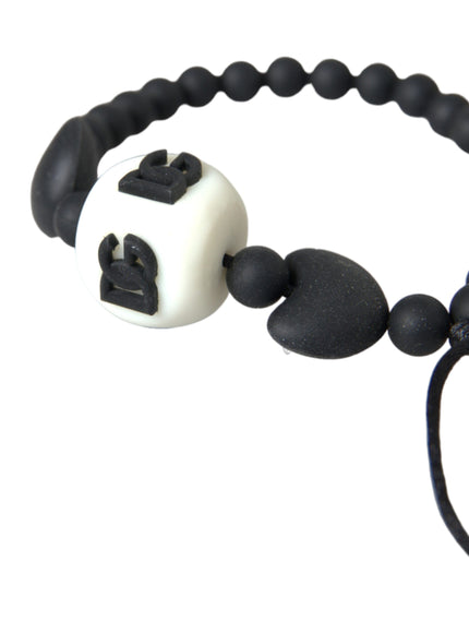 a black and white beaded bracelet with a white ball