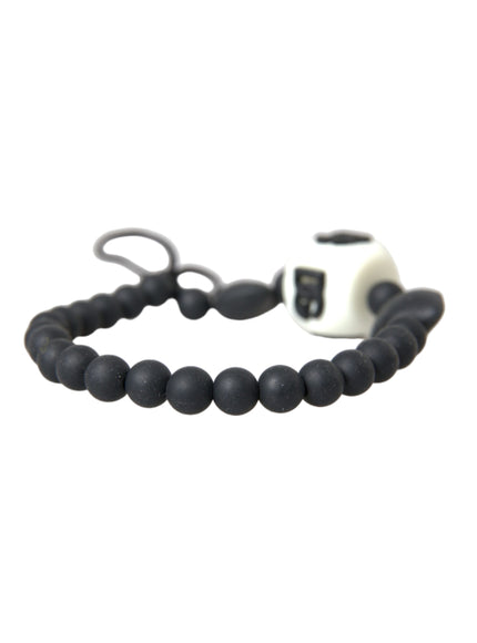 a black and white beaded bracelet with a camera