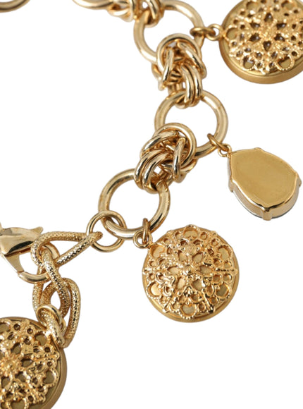 a close up of a gold bracelet with charms