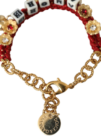 a red and gold bracelet with a charm