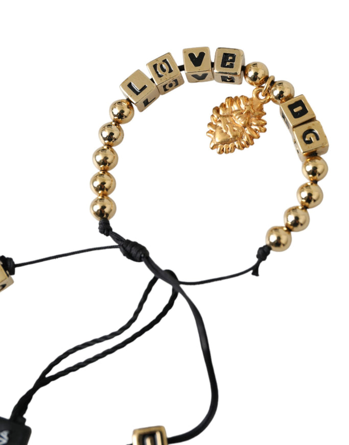 a gold beaded bracelet with a lion head on it