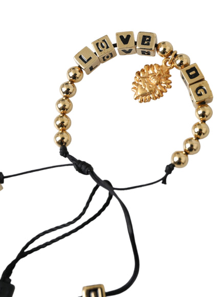 a gold beaded bracelet with a lion head on it