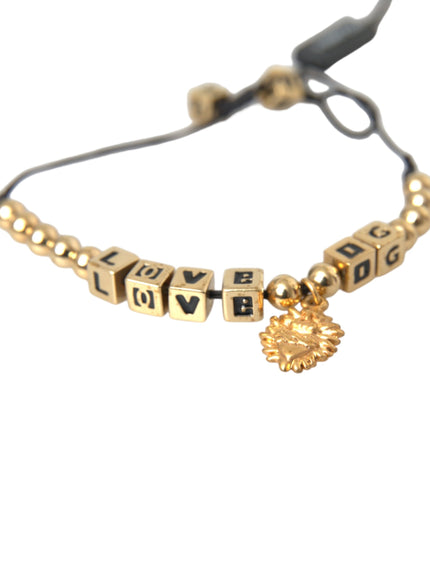 a gold bracelet with words and a heart charm